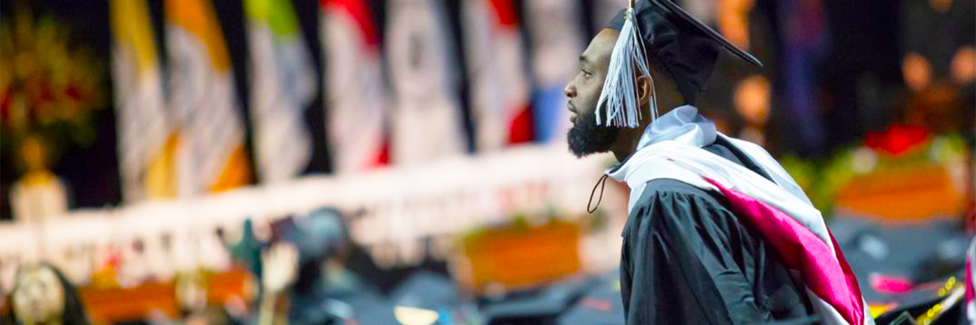 A student stands up at commencement.